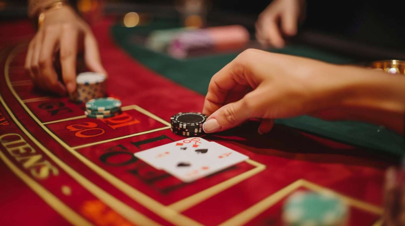 db1978cmd_A_close-up_of_a_persons_hand_placing_chips_on_a_black_24d515a9-a424-4dbd-a8df-8c313d431f03